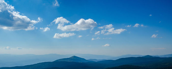 Scenic view of mountains against blue sky