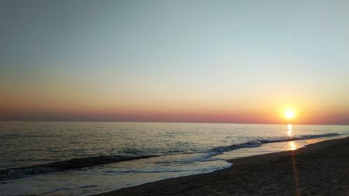 Scenic view of sea against clear sky during sunset