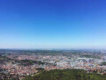 High angle view of cityscape against blue sky