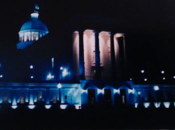 Reflection of illuminated lights in puddle