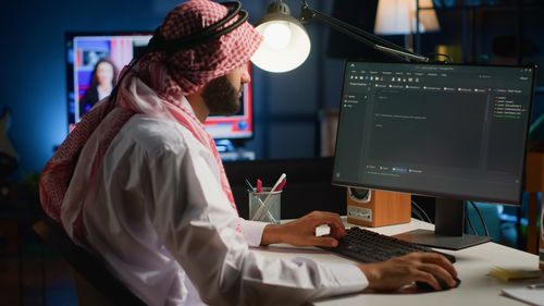 Midsection of woman using laptop