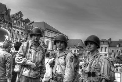 Group of people in front of buildings against sky