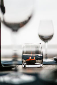 Close-up of wine glasses on table