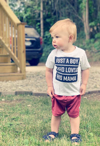 Portrait of boy standing on grassy field