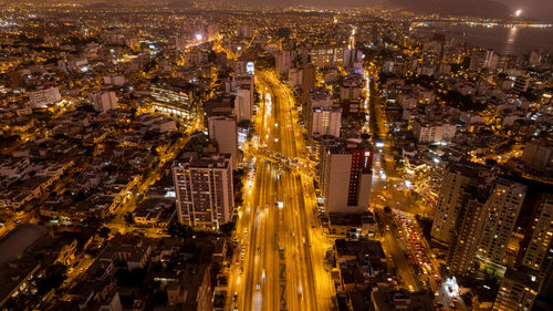 High angle view of illuminated buildings in city at night