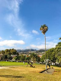 Scenic view of grassy field against sky