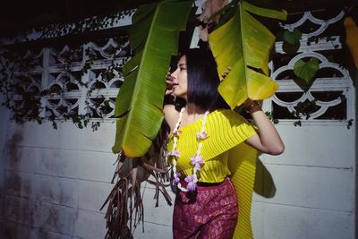 Woman standing against wall