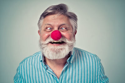 Portrait of man wearing mask against gray background