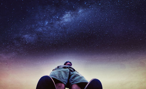 Low angle view of man against sky at night