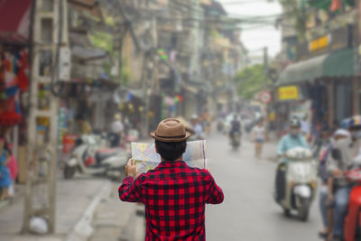 Rear view of woman walking on street