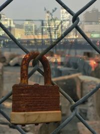 Close-up of padlock on chainlink fence