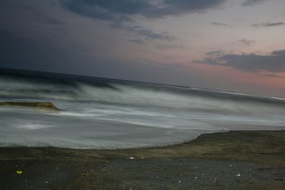 Scenic view of beach against sky during sunset