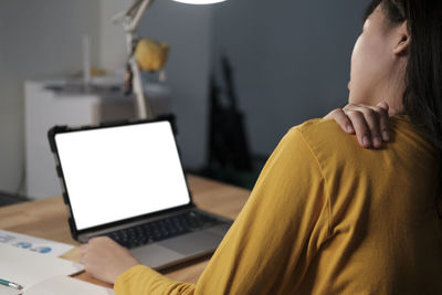 Midsection of woman using mobile phone