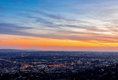 High angle view of illuminated buildings against sky during sunset