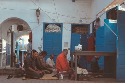 Group of people sitting in front of building