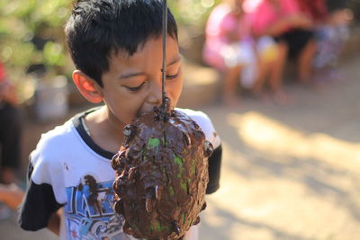 Close-up of boy holding girl