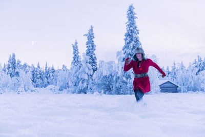 Woman running through snow