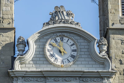 Low angle view of clock tower against building