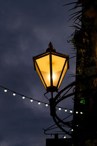 Low angle view of illuminated street light against sky at sunset