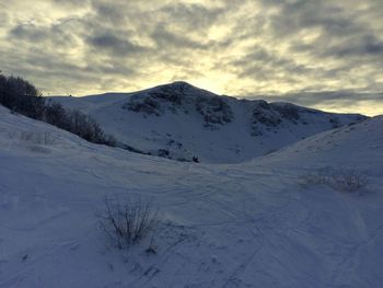 Scenic view of snow covered mountains against sky