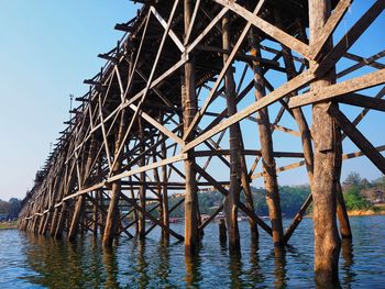 Low angle view of pier over sea against sky