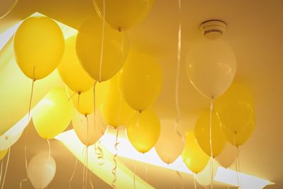 Low angle view of balloons in illuminated room