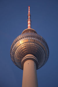Low angle view of tower against blue sky