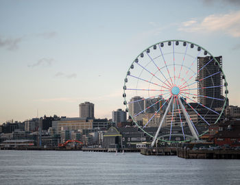 Ferris wheel in city against sky