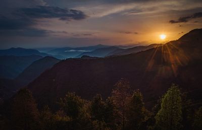 Scenic view of mountains against sky during sunset