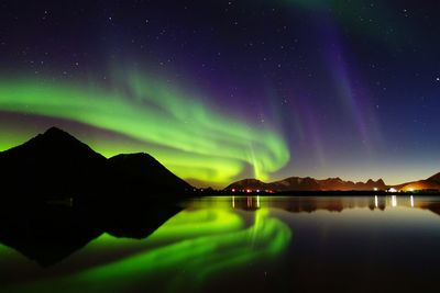 Scenic view of lake against sky at night