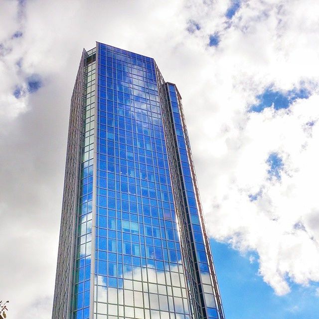 architecture, low angle view, building exterior, built structure, modern, sky, office building, tall - high, skyscraper, cloud - sky, tower, city, glass - material, reflection, cloudy, cloud, building, tall, day, blue