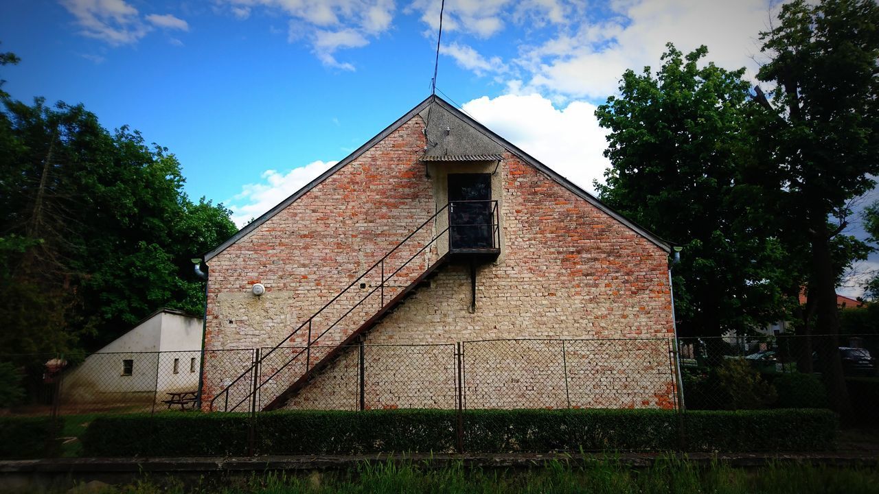 LOW ANGLE VIEW OF OLD BUILDING AND TREES AGAINST SKY