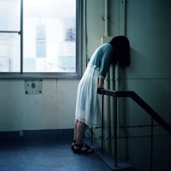 Full length of woman standing on bench