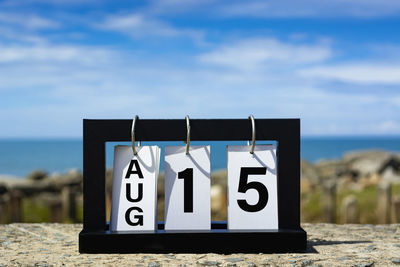 Close-up of information sign at beach