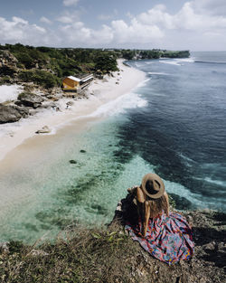 Woman on beach against sky