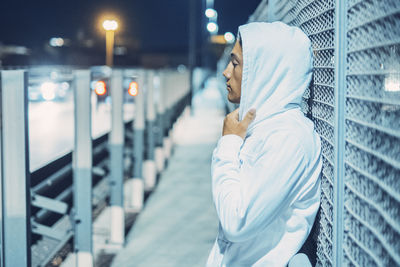 Portrait of young woman standing in city