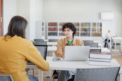 Side view of business colleagues working at office