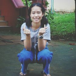 Portrait of smiling girl sitting outdoors