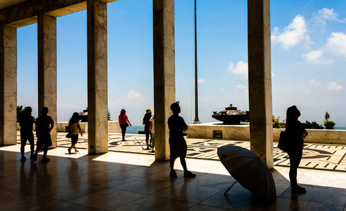 People enjoying at beach against sky