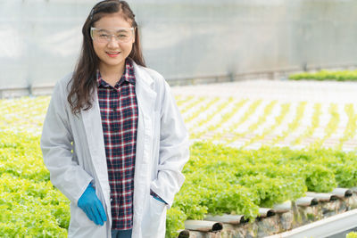 Portrait of a smiling young woman standing outdoors