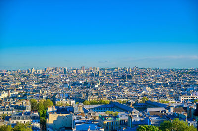 High angle view of townscape against blue sky