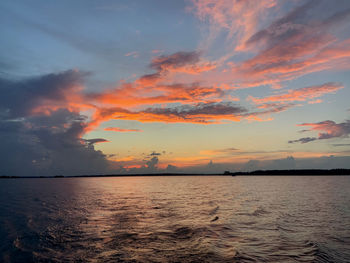 Scenic view of sea against romantic sky at sunset