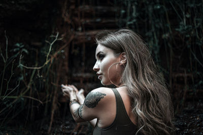 Portrait of young woman in forest