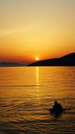 Scenic view of lake at sunset