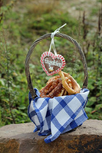 Close-up of wicker basket hanging on wood