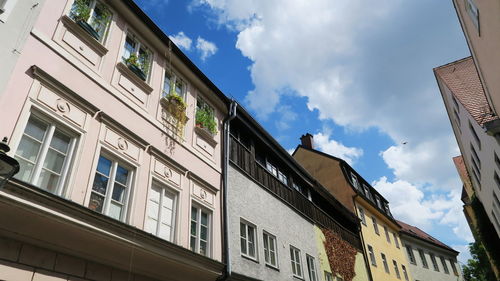 Low angle view of building against cloudy sky