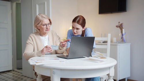 Young woman using laptop at home