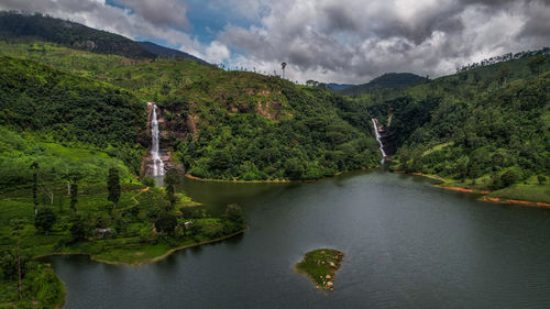 Scenic view of lake and mountains against sky