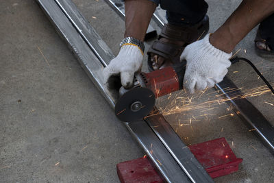 High angle view of man working on metal