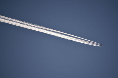 Low angle view of airplane flying in sky